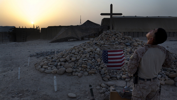 Lt David Kim, a Navy Chaplain attached to 1st Battalion, 5th Marine Regiment looks at the sky after a memorial service to the fallen.